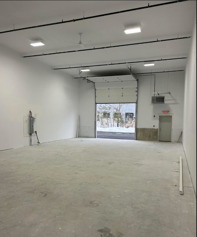 Vacant unit interior at 85 Ledge Road with an overhead door